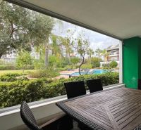 Covered terrace with garden furniture and a view of the pool in Side, Turkey.