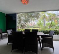 Unique properties with a terrace, rattan furniture, and a garden view.