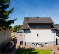 A family house on Jahodova Street in Trenčín with a yard, a car, and greenery.