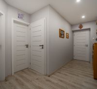 Interior of a family house with white doors and a wooden decor floor.