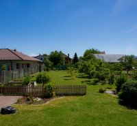 A grassy garden at a family house on Jahodova Street in Trencin with fruit trees.