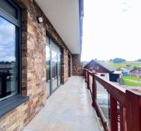 The balcony of commercial premises with a stone facade in Donovaly, Banská Bystrica district.