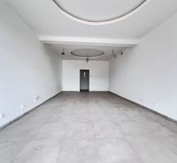 Empty commercial spaces with white walls and ceramic tile flooring.