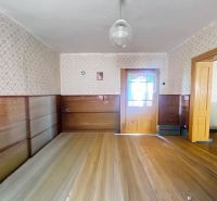 Interior of a family house with wooden doors, wooden paneling, and flooring with a wooden decor.