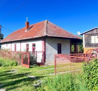 A family house in Žirany, Nitra district, with a red roof and fence.