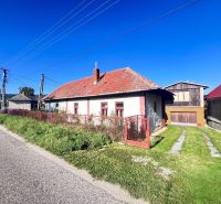 A family house in Žirany, Nitra district, Nitra region with a red roof and a garden.