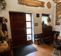 The interior of the villa with wooden animal sculptures and carved decorations on the walls.