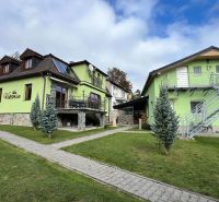 A villa in Štôla, Poprad district, Prešov Region with a colorful facade and a garden.