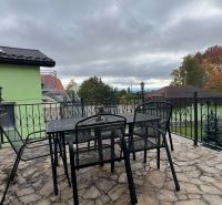 Terrace of the villa in Štôla, Poprad district, Prešov region, with a table and metal chairs.