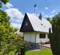 A family house on Horné Otrokovce Street in Horné Otrokovce surrounded by greenery and a blue sky.