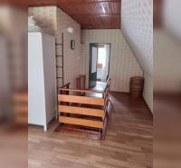 Attic room with wooden decor flooring in a family house.
