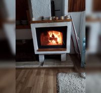 There is a fireplace in the family house on a floor with a wood decor.