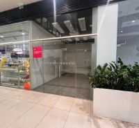 Glass facade of a retail space in a shopping center with a renovation notice.