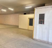 Warehouse and hall spaces with tiled floors and white walls, ideal for storage.