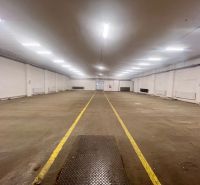 A wide warehouse interior with lighting and marked flooring in the space of warehouses and halls.