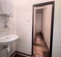 Interior of a bathroom in warehouses and halls with a sink and a wall-mounted water heater.