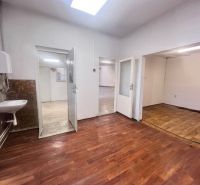 Interior of a warehouse and hall with a wooden decor floor and a sink on the wall.