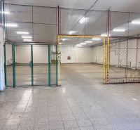 Interiors of warehouses and halls with tiling and metal fencing.
