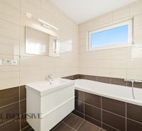 Bathroom with a shower in a 3-room apartment with tiles and a sink.