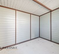 An interior with metal walls and a concrete floor in a 3-room apartment.