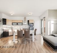 A kitchen with a dining table in a 3-room apartment, floor with wood decor.