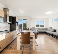 3-room apartment with a kitchen, living room, wooden decor flooring, and a large window.