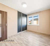 A room in a 3-room apartment with a wooden decor floor and a built-in wardrobe.