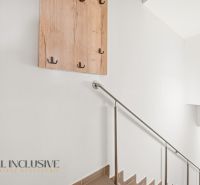 A staircase with a metal railing and wall hooks in a 3-room apartment.