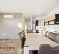 A kitchen with a dining table in a 3-room apartment, floor with wood decor.