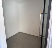 A small room in a family house with white walls and tiles.