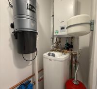 Boiler room in a family house with a boiler and a central vacuum system.