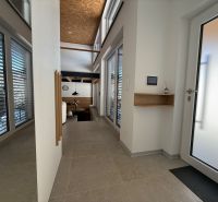 Entrance hall in a family house with large windows and skylights.