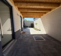 A family house in Piešťany on Orviský kút with a recessed terrace and paving.