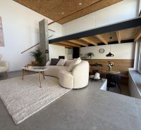 Living room in a family house with comfortable furniture and wall decorations.
