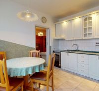 A bright kitchen with a table and chairs in a 3-room apartment with a practical layout.