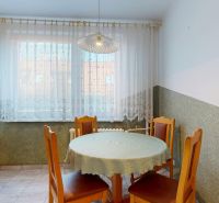 Dining area with a table and chairs in a 3-room apartment.