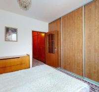 A bedroom with a large wardrobe and a painting, part of a 3-room apartment.