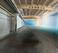 Production premises with a concrete floor and light walls, reinforced ceiling.