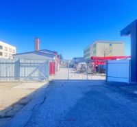 Production facilities on Majerská cesta in Banská Bystrica with a gate and industrial buildings.