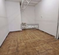 An office interior with white walls and brown tiles.