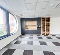 Office space with a large window, built-in cabinets, and a checkered floor.