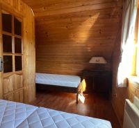 Wooden interior with two beds, bedroom in a cabin, floor with wooden decor.