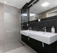 Stylish bathroom with two sinks and a shower in a 3-room apartment on Továrenská Street.