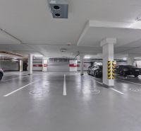 Underground parking on Továrenská Street, spacious underground parking near a 3-room apartment.