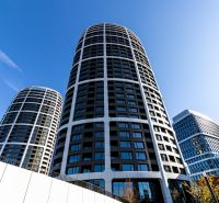 The high-rise building on Továrenská Street, suitable for a 3-room apartment, dominates the city skyline.