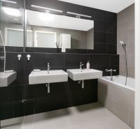 Cozy bathroom on Továrenská Street in a 3-room apartment with a bathtub and double sink.