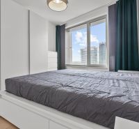 Bedroom in a 3-room apartment with wooden flooring, view on Továrenská street.