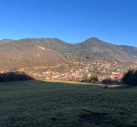 The landscape in the village of Ľubietová surrounded by mountains, village architecture, and a peaceful environment.