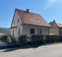 A family house in Podháj with a red roof and a garden, Banská Bystrica district.