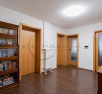 Interior of a family house with wooden floor decoration and a bookshelf.
